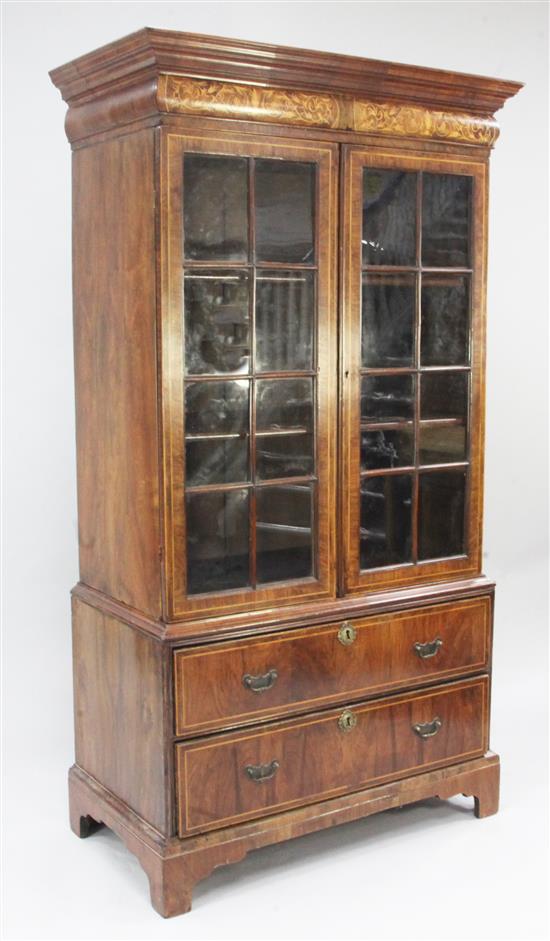 A walnut featherbanded and boxwood line inlaid bookcase, W.3ft